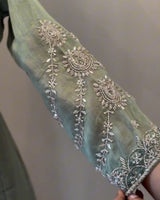 Decorative fabric with intricate silver embroidery on a plain background